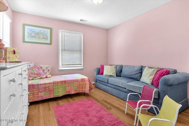 939 Ocean Blvd W, Holden Beach, NC 28462 - bedroom with light wood-style flooring and a textured ceiling