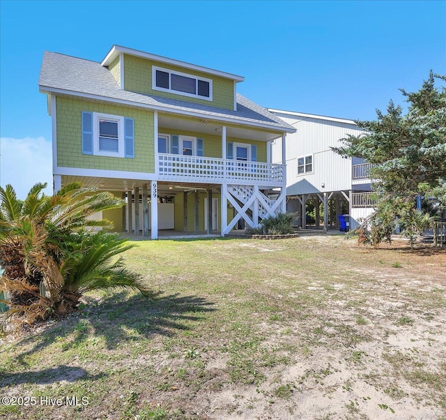 939 Ocean Blvd W, Holden Beach, NC 28462 - view of front of property featuring a carport, roof with shingles, a porch, and stairs