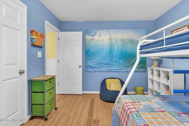 939 Ocean Blvd W, Holden Beach, NC 28462 - bedroom with wood finished floors, baseboards, and a textured ceiling