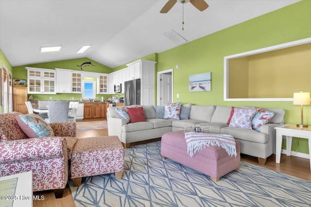 939 Ocean Blvd W, Holden Beach, NC 28462 - living room featuring light wood-style flooring, vaulted ceiling, and a ceiling fan