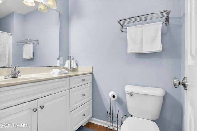 939 Ocean Blvd W, Holden Beach, NC 28462 - bathroom featuring toilet, vanity, and baseboards