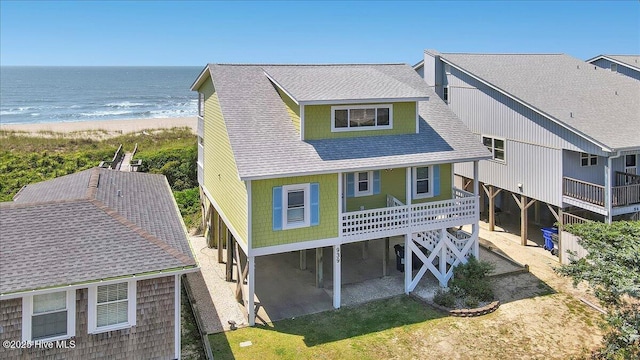 939 Ocean Blvd W, Holden Beach, NC 28462 - rear view of house featuring roof with shingles, view of water and beach, and a patio area