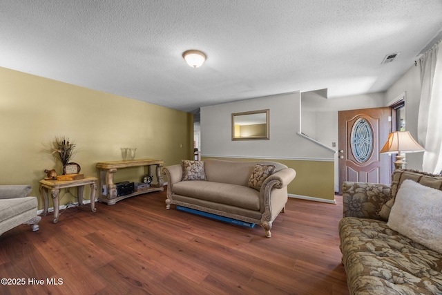 119 Cobblestone Trl, Jacksonville, NC 28546 - living room featuring wood finished floors, a textured ceiling, and baseboards