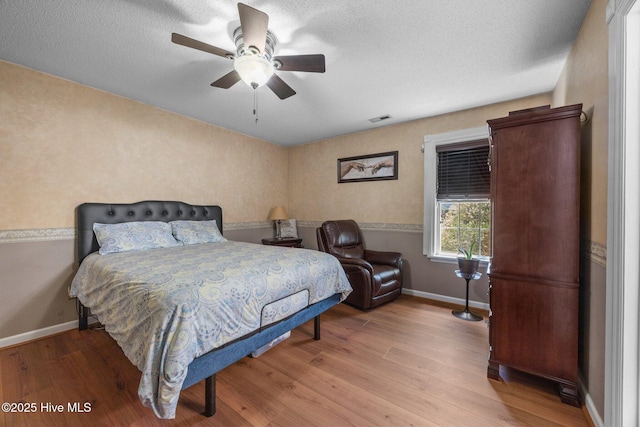 119 Cobblestone Trl, Jacksonville, NC 28546 - bedroom with wood finished floors, baseboards, a ceiling fan, and a textured ceiling