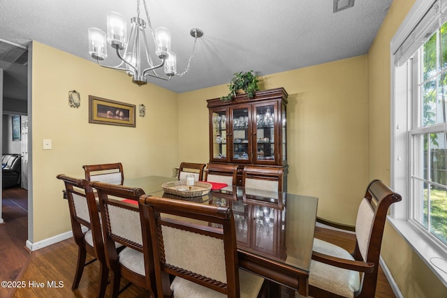 119 Cobblestone Trl, Jacksonville, NC 28546 - dining space with dark wood-style floors, a chandelier, baseboards, and a textured ceiling