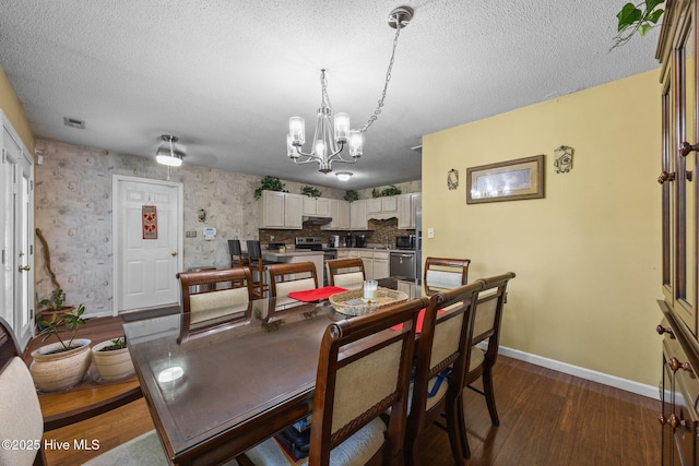 119 Cobblestone Trl, Jacksonville, NC 28546 - dining space featuring dark wood-style floors, baseboards, a chandelier, and a textured ceiling