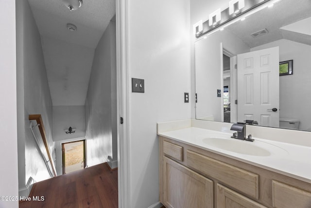 119 Cobblestone Trl, Jacksonville, NC 28546 - bathroom with vanity, vaulted ceiling, toilet, and baseboards