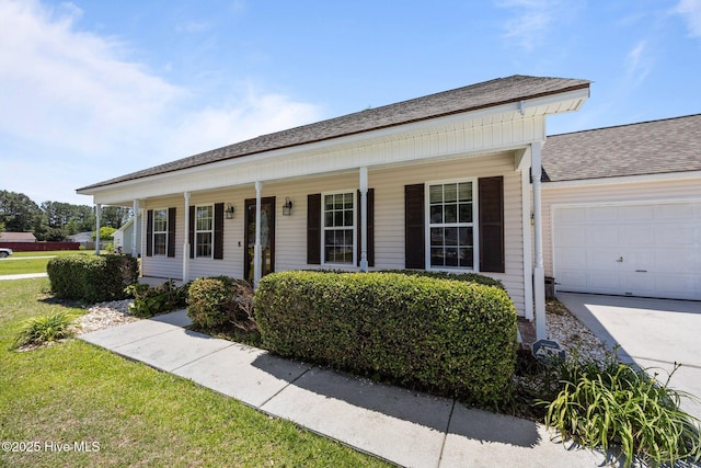 119 Cobblestone Trl, Jacksonville, NC 28546 - view of front of home featuring a garage, covered porch, driveway, and roof with shingles