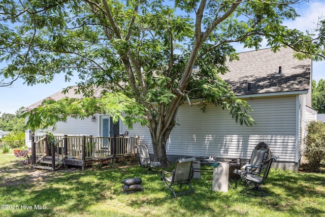 119 Cobblestone Trl, Jacksonville, NC 28546 - rear view of house with a deck, a lawn, and a shingled roof