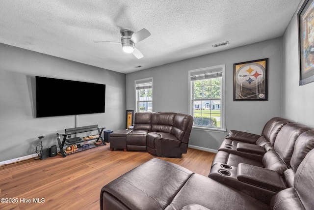 119 Cobblestone Trl, Jacksonville, NC 28546 - living area featuring wood finished floors, a ceiling fan, a textured ceiling, and baseboards