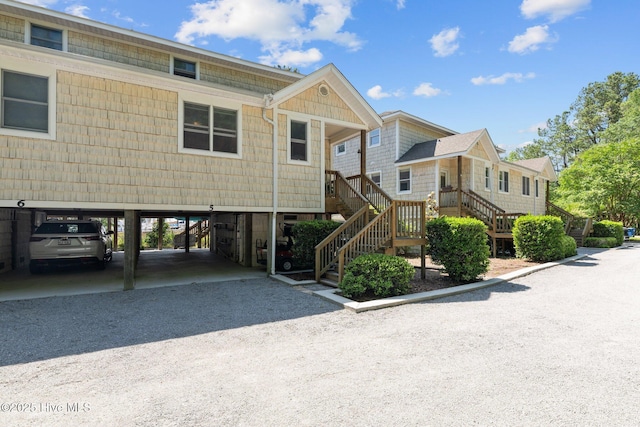 1404 Tosto Cir Apt 5, Oriental, NC 28571 - view of property with stairway, a carport, and gravel driveway