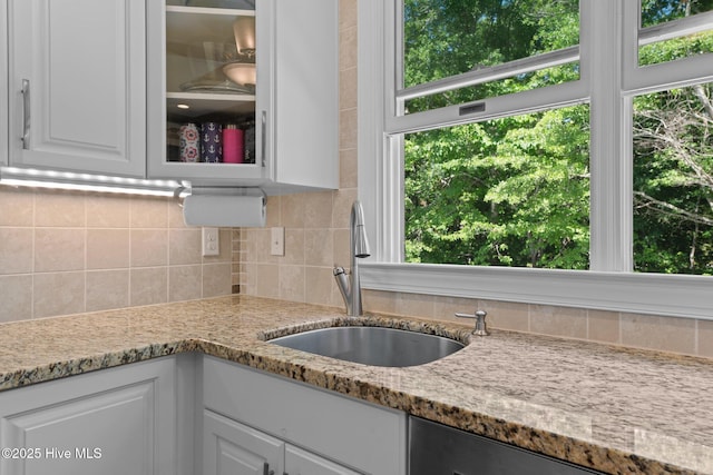1404 Tosto Cir Apt 5, Oriental, NC 28571 - kitchen with a sink, backsplash, white cabinets, and light stone countertops