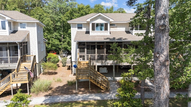 1404 Tosto Cir Apt 5, Oriental, NC 28571 - view of front of house with stairway, a sunroom, and a shingled roof