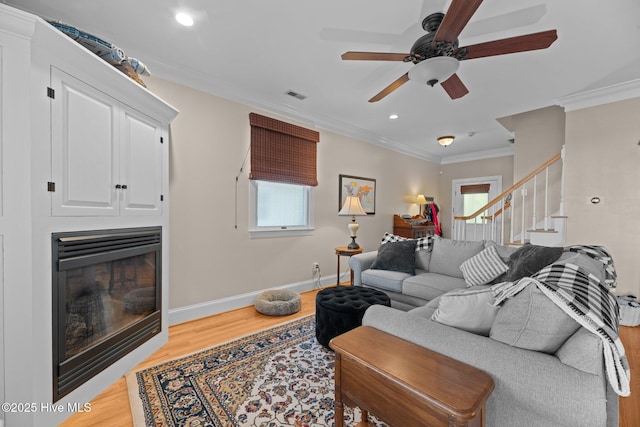 1404 Tosto Cir Apt 5, Oriental, NC 28571 - living area featuring plenty of natural light, ornamental molding, stairway, ceiling fan, and wood finished floors