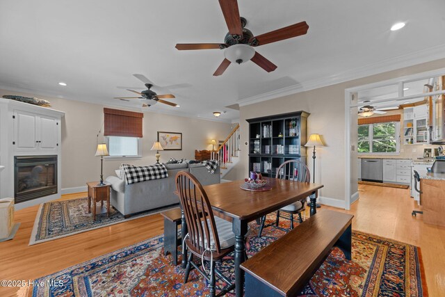 1404 Tosto Cir Apt 5, Oriental, NC 28571 - dining space with ceiling fan, a glass covered fireplace, light wood-style flooring, stairs, and recessed lighting