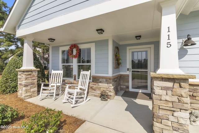 115 Norman Cir, Aberdeen, NC 28315 - view of exterior entry featuring covered porch and stone siding