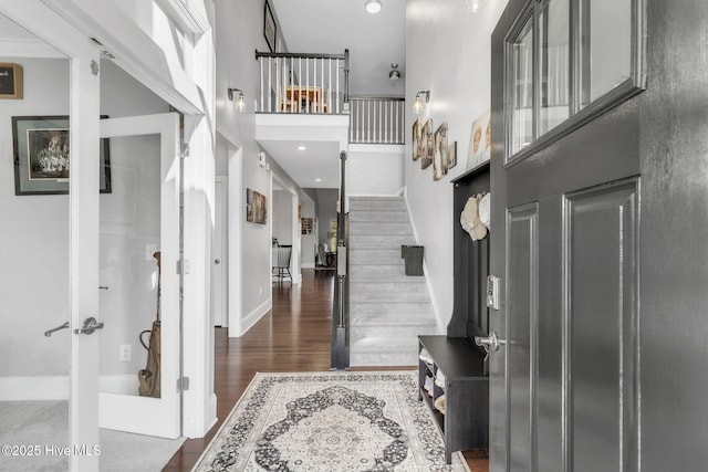 115 Norman Cir, Aberdeen, NC 28315 - entrance foyer featuring dark wood-style flooring, stairway, a towering ceiling, and baseboards