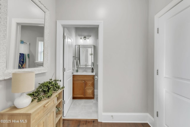 115 Norman Cir, Aberdeen, NC 28315 - hall featuring a sink, wood finished floors, and baseboards