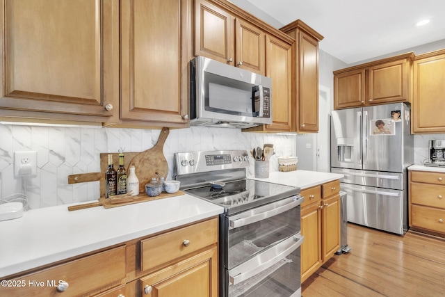 115 Norman Cir, Aberdeen, NC 28315 - kitchen with stainless steel appliances, light countertops, decorative backsplash, light wood finished floors, and recessed lighting