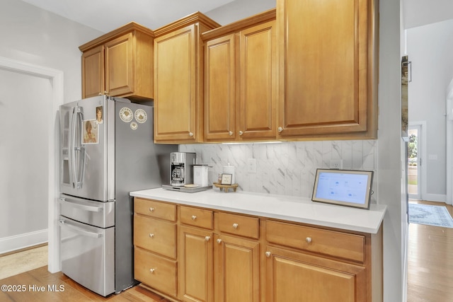 115 Norman Cir, Aberdeen, NC 28315 - kitchen featuring stainless steel refrigerator with ice dispenser, light wood-style flooring, backsplash, and light countertops