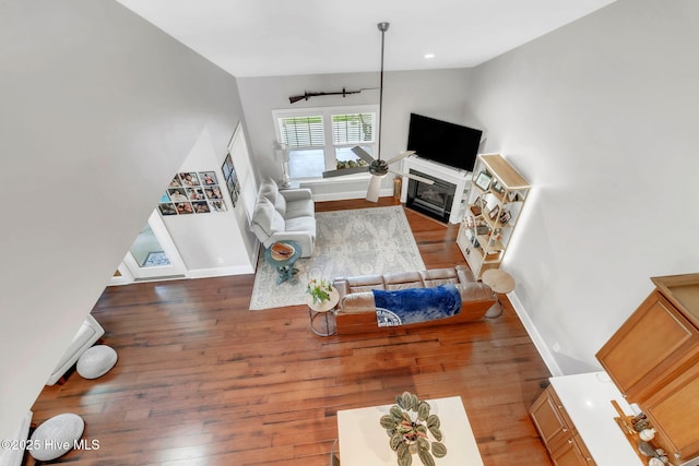 115 Norman Cir, Aberdeen, NC 28315 - living room with wood finished floors, baseboards, a glass covered fireplace, and vaulted ceiling
