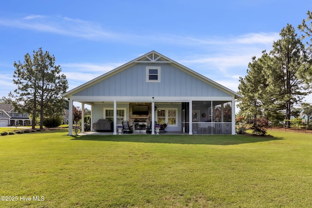 115 Norman Cir, Aberdeen, NC 28315 - rear view of property featuring board and batten siding, a yard, a patio, and a sunroom