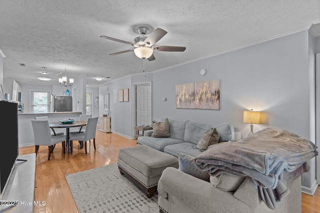 1825 Savannah Ct Unit D3, Wilmington, NC 28403 - living area featuring a textured ceiling, a ceiling fan, light wood finished floors, crown molding, and a chandelier