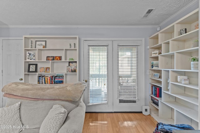 1825 Savannah Ct Unit D3, Wilmington, NC 28403 - sitting room with light wood-style flooring, a textured ceiling, and crown molding