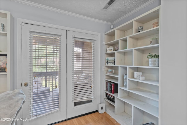 1825 Savannah Ct Unit D3, Wilmington, NC 28403 - doorway with light wood-style floors, crown molding, and a textured ceiling
