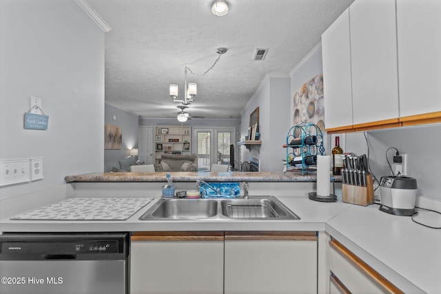 1825 Savannah Ct Unit D3, Wilmington, NC 28403 - kitchen featuring stainless steel dishwasher, white cabinets, a sink, a textured ceiling, and light countertops