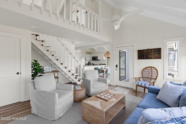 305 S Bald Head Wynd Wynd Unit 16, Bald Head Island, NC 28461 - living room with wood finished floors, high vaulted ceiling, stairs, beamed ceiling, and ceiling fan