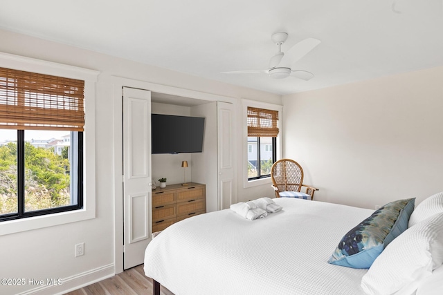 305 S Bald Head Wynd Wynd Unit 16, Bald Head Island, NC 28461 - bedroom with light wood finished floors, a ceiling fan, and baseboards