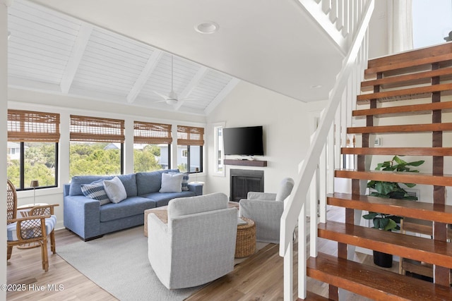 305 S Bald Head Wynd Wynd Unit 16, Bald Head Island, NC 28461 - living area featuring stairway, light wood-style floors, high vaulted ceiling, a fireplace, and beam ceiling