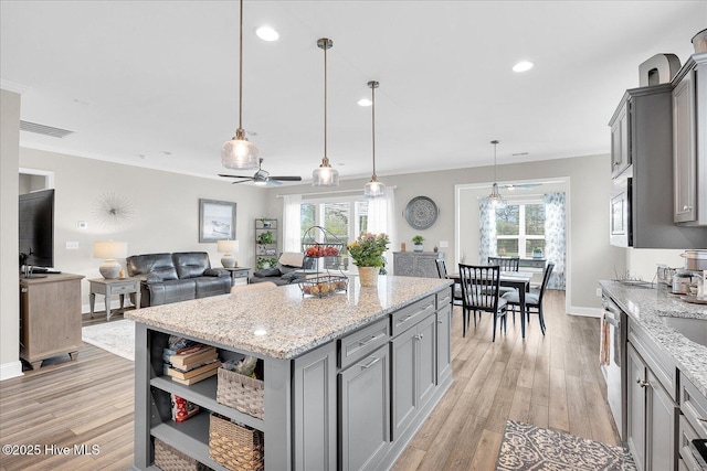 3213 Laughing Gull Ter, Wilmington, NC 28412 - kitchen featuring gray cabinets, light wood-style flooring, plenty of natural light, a ceiling fan, and recessed lighting