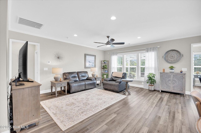 3213 Laughing Gull Ter, Wilmington, NC 28412 - living room featuring healthy amount of natural light, light wood-type flooring, crown molding, ceiling fan, and recessed lighting