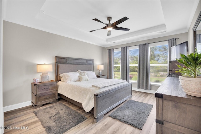 3213 Laughing Gull Ter, Wilmington, NC 28412 - bedroom with a tray ceiling, light wood-style floors, baseboards, crown molding, and ceiling fan