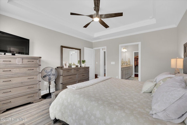 3213 Laughing Gull Ter, Wilmington, NC 28412 - bedroom with a tray ceiling, light wood-style flooring, crown molding, baseboards, and connected bathroom