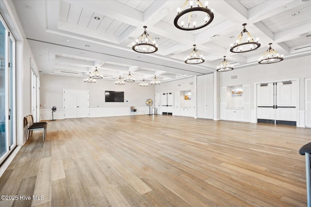 3213 Laughing Gull Ter, Wilmington, NC 28412 - unfurnished living room featuring a chandelier, coffered ceiling, light wood finished floors, and beam ceiling