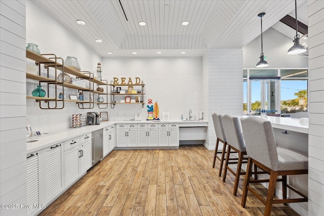 3213 Laughing Gull Ter, Wilmington, NC 28412 - kitchen featuring open shelves, light wood finished floors, light countertops, wood ceiling, and recessed lighting