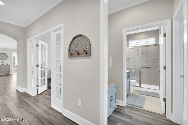 3213 Laughing Gull Ter, Wilmington, NC 28412 - hallway with arched walkways, ornamental molding, wood finished floors, french doors, and baseboards