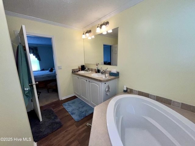 22541 Henry St, Laurel Hill, NC 28351 - full bath featuring ornamental molding, wood finished floors, a textured ceiling, double vanity, and connected bathroom
