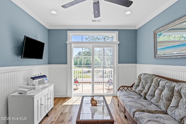 341 Bay Hill Ct, Shallotte, NC 28470 - living area featuring wainscoting, light wood-style flooring, a ceiling fan, and crown molding