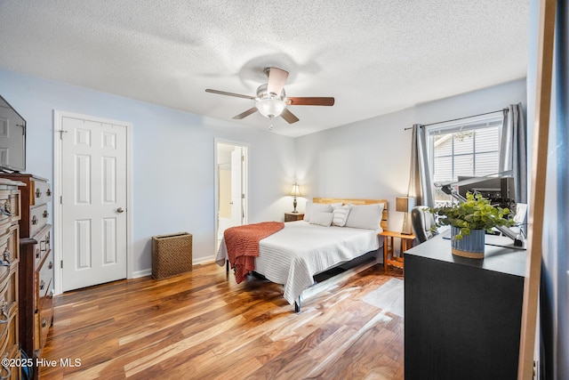 130 Woodgreen Ln, Aberdeen, NC 28315 - bedroom featuring wood finished floors, a textured ceiling, ceiling fan, and baseboards