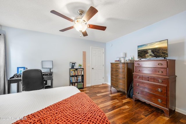 130 Woodgreen Ln, Aberdeen, NC 28315 - bedroom featuring dark wood-style flooring, baseboards, a desk, and a ceiling fan