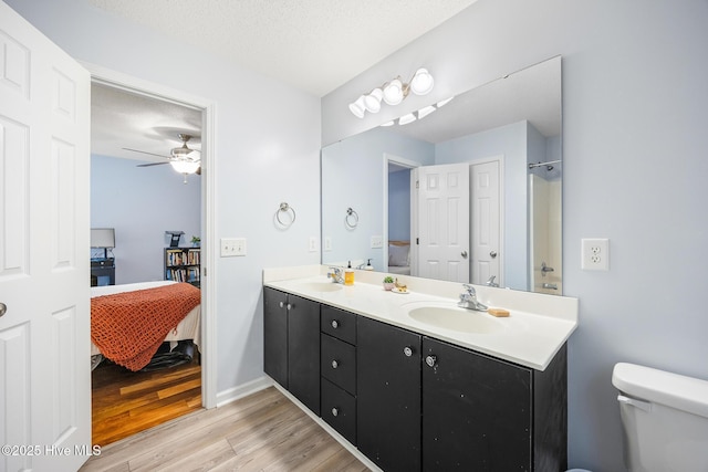 130 Woodgreen Ln, Aberdeen, NC 28315 - full bathroom with wood finished floors, double vanity, connected bathroom, toilet, and ceiling fan