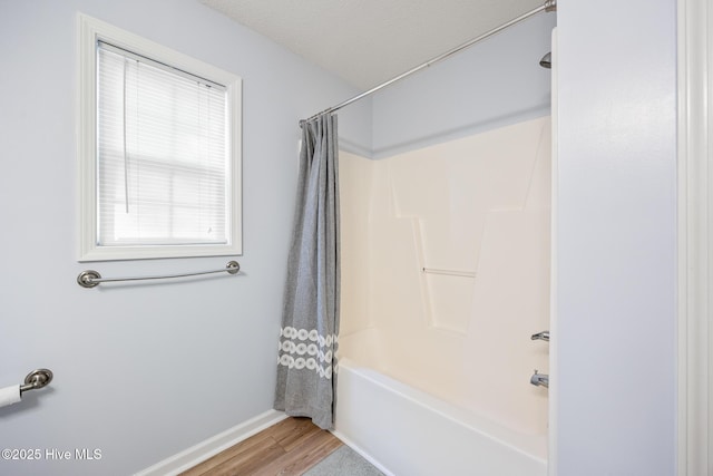 130 Woodgreen Ln, Aberdeen, NC 28315 - full bathroom featuring wood finished floors, shower / bathtub combination with curtain, and baseboards