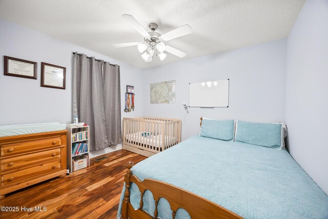 130 Woodgreen Ln, Aberdeen, NC 28315 - bedroom featuring wood finished floors, a ceiling fan, and a textured ceiling