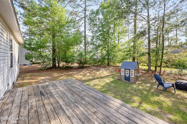 130 Woodgreen Ln, Aberdeen, NC 28315 - wooden deck featuring an outdoor fire pit and a lawn