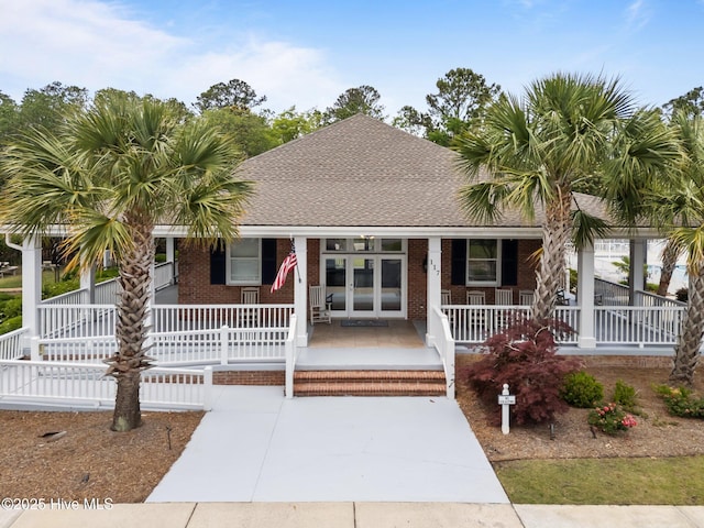 513 Belhaven Dr, Wilmington, NC 28411 - view of front facade featuring covered porch, a shingled roof, and brick siding
