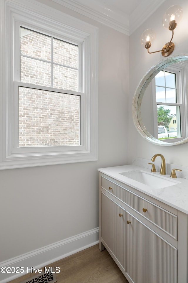 1401 Regatta Dr, Wilmington, NC 28405 - bathroom with vanity, baseboards, wood finished floors, and ornamental molding